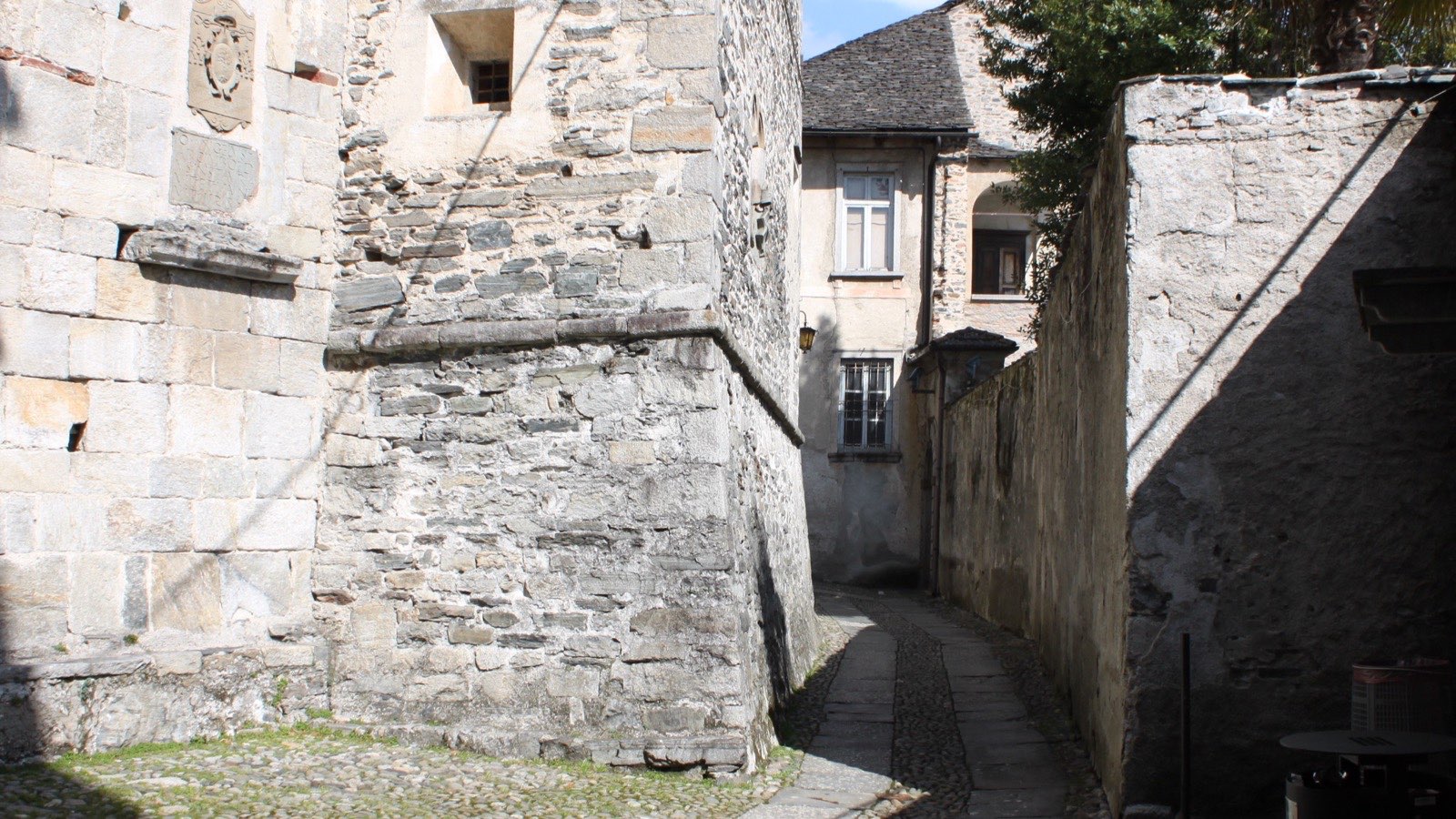 A cobbled lane between stone walls on Isola San Giulio, Lake Orta