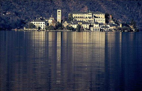 San Giulio Island reflected in the crystal clear waters of Lake Orta, restored to pristine condition after the liming miracle
