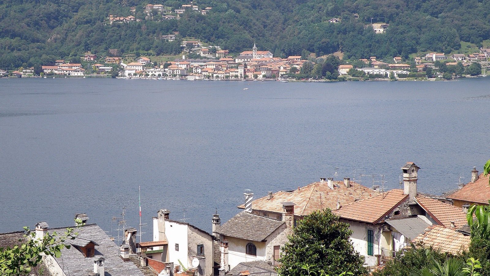 Les toits d'Orta San Giulio et le lac d'Orta avec le village de Pella sur la rive opposée