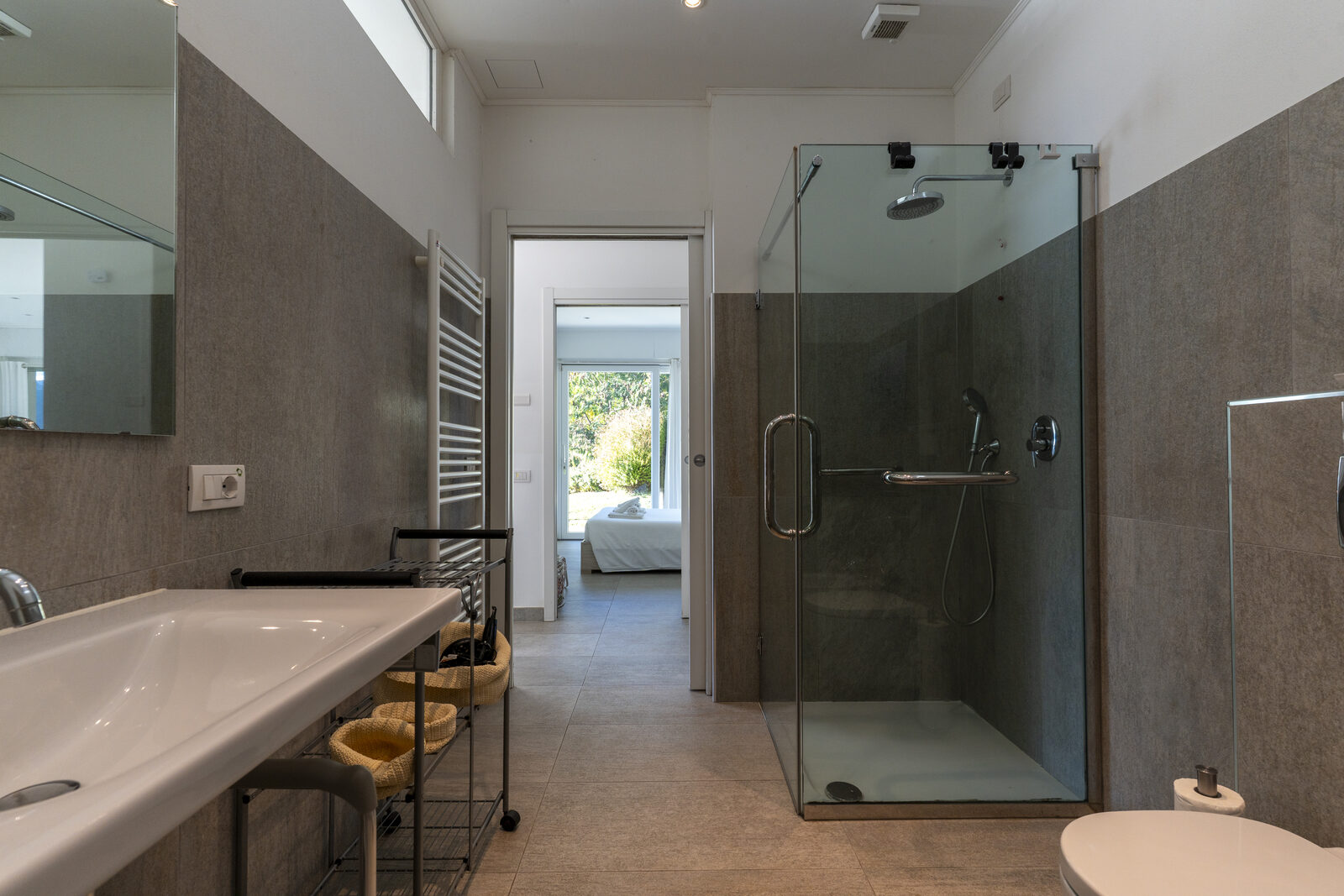 Walk-in shower with grab handles and movable seat