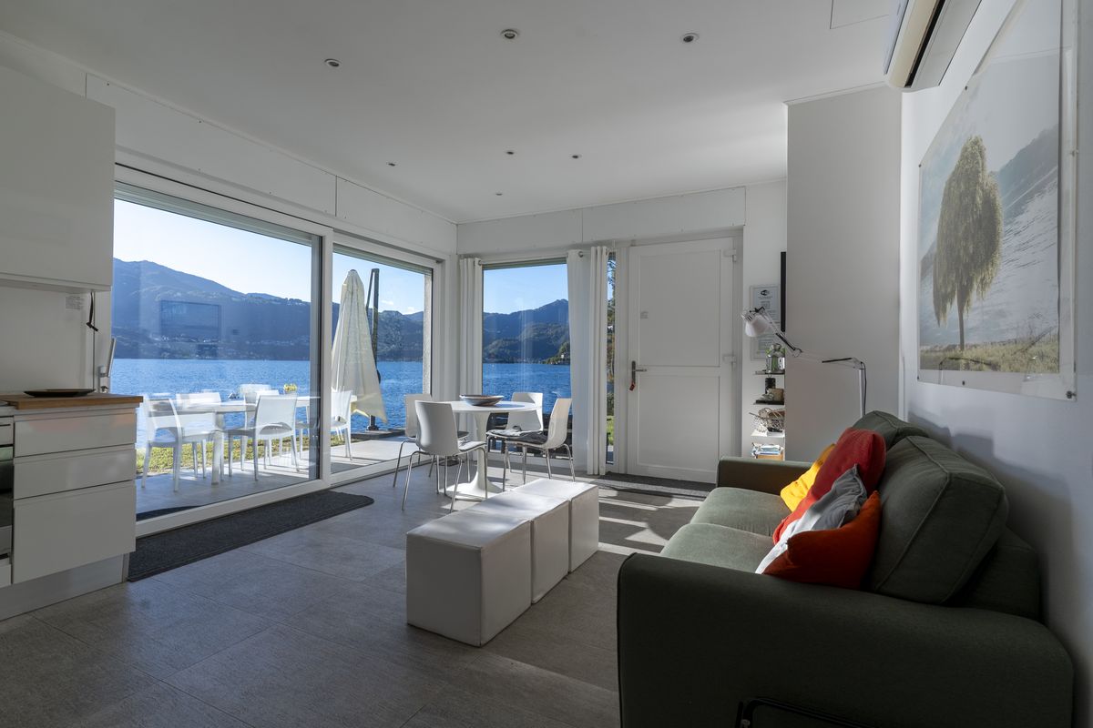 Living room with sofa and a panoramic view of the lake